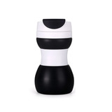 A drink bottle featuring a collapsible silicone design in black and white, showcasing a sleek, modern style with a logo.