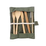 A bamboo cutlery set in a green fabric wrap, including a fork, knife, spoon, and straw.
