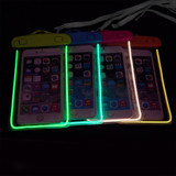 Four waterproof phone bags in vibrant colours, featuring fluorescent outlines and interlocking closures, each holding a phone.