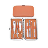 A stylish manicure set in a silver case with an orange interior, containing various nail care tools.