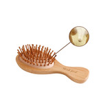 A small bamboo hairbrush with wooden bristles and a natural finish. It features a branded logo on the handle.