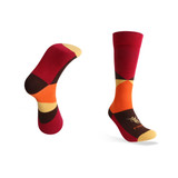 Mid-calf socks in a bold pattern featuring red, orange, brown, and yellow colours, with a logo on one sock.
