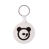 A round hard plastic keyring in white with a black bear logo and a silver keyring attachment.