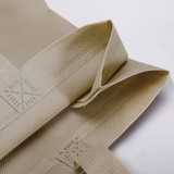 A light beige Kraft paper bag with a laminated finish and woven lining, featuring a textured surface and folded edges.