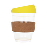 A reusable glass coffee cup with a cork band and a yellow lid, featuring a clear body.
