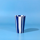 A drink cup featuring a blue and white striped design, with a glossy finish and a slightly tapered shape.