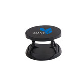 A round black phone holder with a logo, featuring adjustable arms for stability. Ideal for phone support.