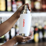 A drink bottle features a sleek white design with a stainless steel top and a logo. Ideal for beverages.