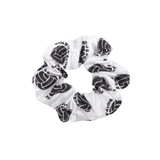 A white hair scrunchie with a black design and logo pattern throughout.