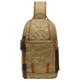 A waxed canvas camera sling bag in khaki and brown, featuring leather accents and a logo.