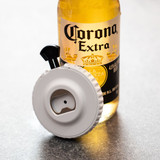 A drink bottle with a white spinner and black bottle opener attached, featuring a logo on the bottle.