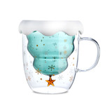 A double wall mug shaped like a Christmas tree, featuring a frosted white top, blue interior, and festive gold and silver details.