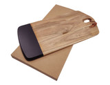 A wooden cheese board with a black edge, resting on a brown cardboard base. Features a handle for easy carrying.