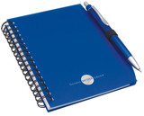 A blue notepad with a spiral binding and a matching pen, featuring a logo on the cover.