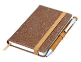 A brown bonded leather notebook with an elastic band and a pen attached, featuring a textured cover.