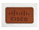 A tan leather patch with a logo on a beige fabric background.