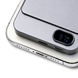 A grey power bank with a digital display showing battery percentage, designed for wireless charging.