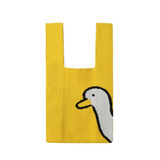 A knitted handbag in yellow featuring a duck design on one side and a square opening at the top.