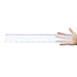 A transparent 30cm ruler held in a hand, featuring measurements in centimeters and inches.