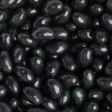 A close-up of glossy black jelly beans, showcasing their smooth, shiny surface and varied shades of black.
