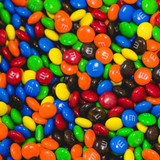 A colorful assortment of M&M's in various shades, including red, blue, green, yellow, and orange, scattered together.