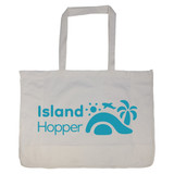 A large, white reusable grocery bag with blue branding featuring tropical elements like a palm tree and an airplane.
