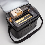 A grey insulated hamper with a wooden cheese board, utensils, and snacks inside, featuring a logo on the exterior.