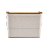 A dual-compartment lunch box in a light, speckled colour with a wooden lid and a simple, modern design.