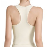 A seamless women's yoga bra tank in cream, featuring wide straps and a racerback design. It has a logo on it.