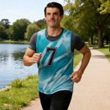 A training bib in aqua and blue tones with a number 7, worn by a man jogging by a lake.