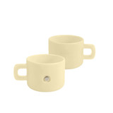 A cream-coloured ceramic mug with a magnetic feature and a handle, showcasing a sleek, minimalist design.
