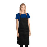 A black chef's apron worn by a model, paired with a blue T-shirt. The apron features a logo.