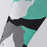 Knee high socks featuring a bold design in teal, black, grey, and white, with visible branding.