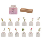 A floral-themed desk calendar for 2026 with a wooden stand. Features various flowers and pastel colours.