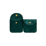 A square velvet jewelry pouch in deep green, featuring a gold snap closure and two compartments.