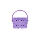 A silicone bag in lavender with a textured handle and perforations, featuring a zip closure and branding.