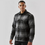 A men's black and grey plaid jacket with a Sherpa lining and button front, featuring two chest pockets and a logo.