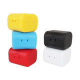 A stack of four travel adapter kits in yellow, blue, red, and black. Each kit features a clasp closure.