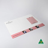 A3 magnetic whiteboard in white featuring a pink notepad, with a logo and branding on the bottom section.