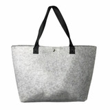 A grey felt shopping bag with black handles, featuring a logo on the side.