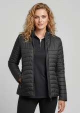 A women's puffer jacket in dark grey, featuring a fitted design and zip pockets, with a model wearing it.