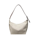 A cream-coloured tote bag with a brown shoulder strap and a smooth finish. It features a simple design and has a logo.