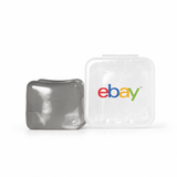 A grey jelly cube sensory toy next to a transparent container featuring a logo.