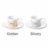 A coffee mug set featuring two dynamic ceramic mugs in golden and silvery finishes, each with a matching saucer and branding.