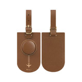 A brown leather luggage tag with a circular attachment and a strap, featuring a logo.