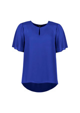 A blue women's short sleeve blouse with a keyhole detail and a flowing hemline. It features a logo.