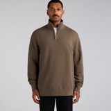 A man wearing a brown half zip crew jumper with long sleeves and a zipper collar. The product has a logo.