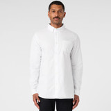 A white button-up Oxford shirt on a model, featuring a chest pocket and long sleeves. The shirt has a logo. A white button-up Oxford shirt on a model, featuring a chest pocket and long sleeves. The shirt has a logo.