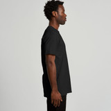 A black recycled t-shirt displayed on a model from the side, featuring a simple design and a logo.