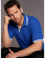 A blue polo shirt featuring white detailing on the collar and sleeves, modelled by a man.